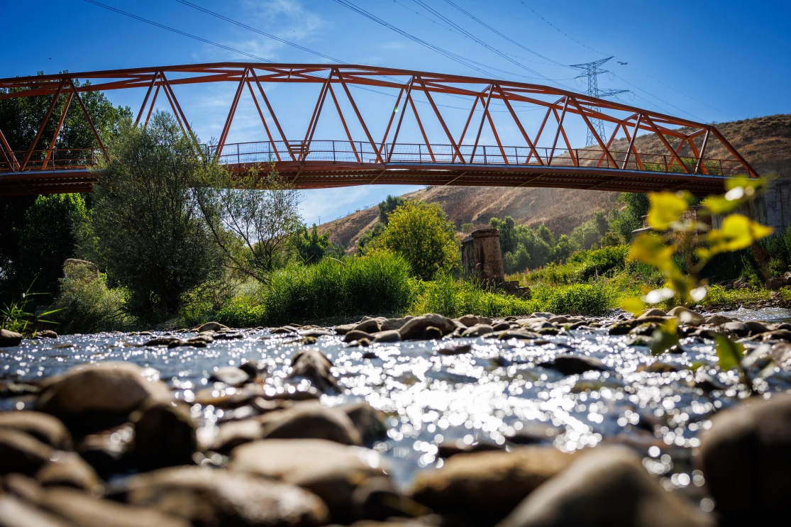 A red bridge over running water. 