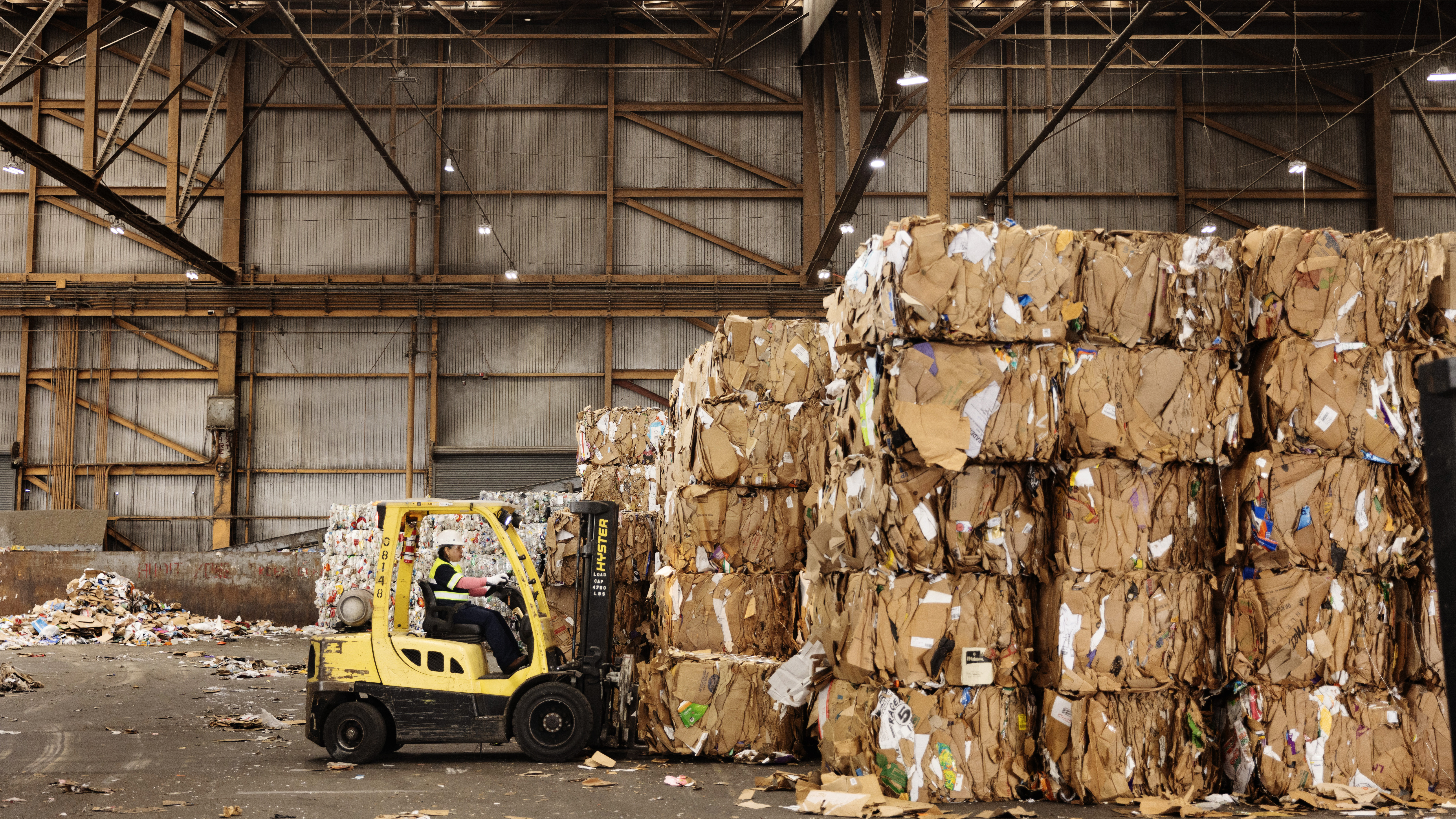 Stacks of cardboard in a warehouse, ready for recycling and reuse. 