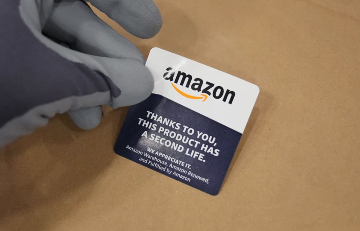 A gloved hand places a label on cardboard that says "thanks to you, this proudct has a second life."