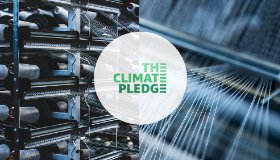 The Climate Pledge logo is shown over a photo of machinery. 