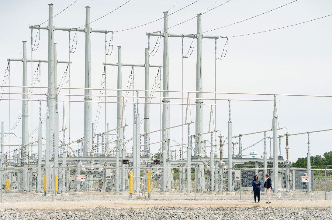 Haley Fisackerly and Kamisha Quates, vice president of reliability at Entergy Mississippi, meet near an electrical substation in Mississippi.