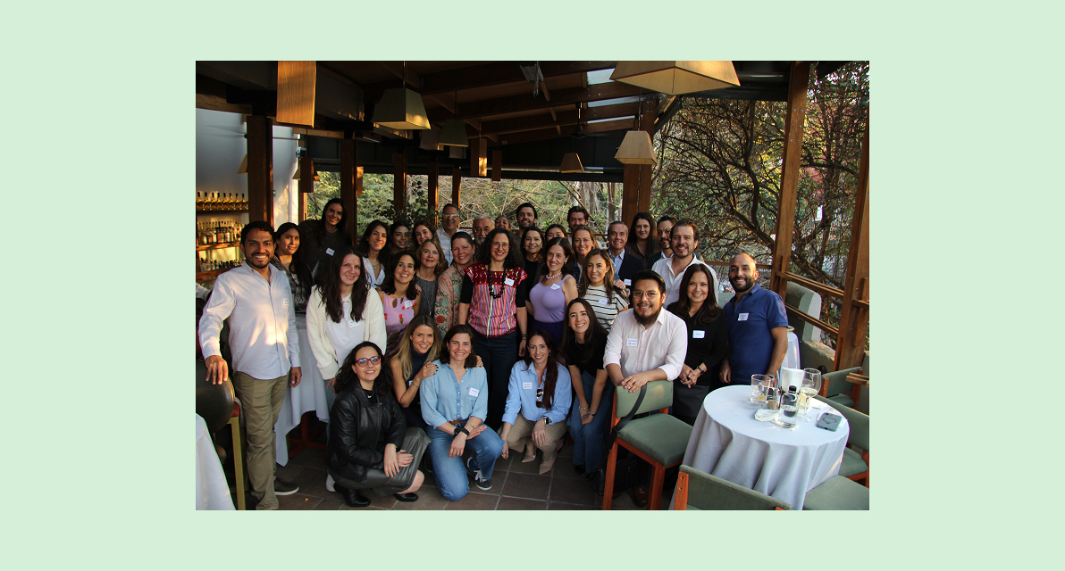 A large group of people smile for photo. 