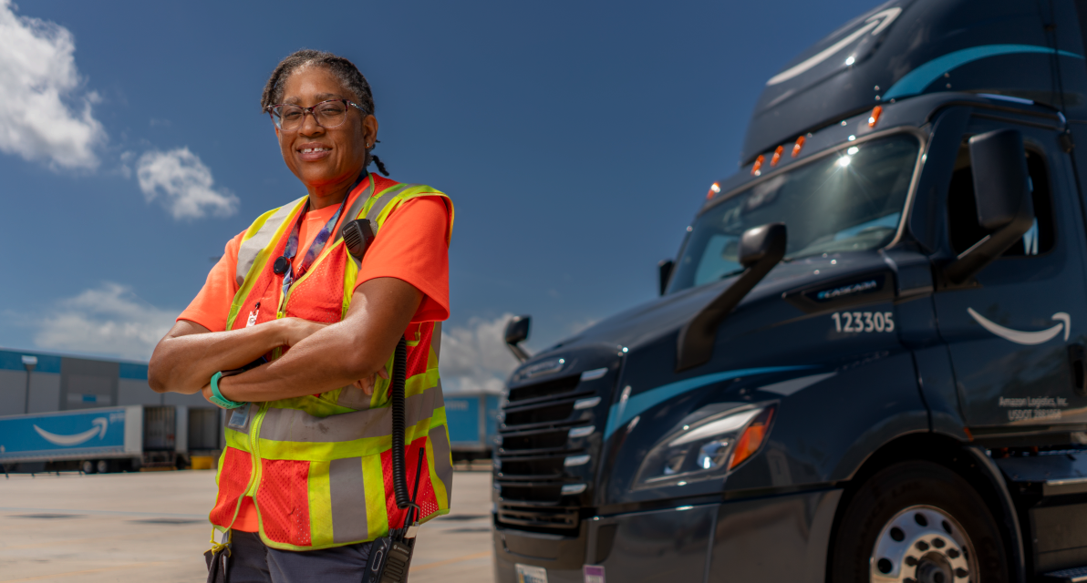 A person stands next to a truck. 