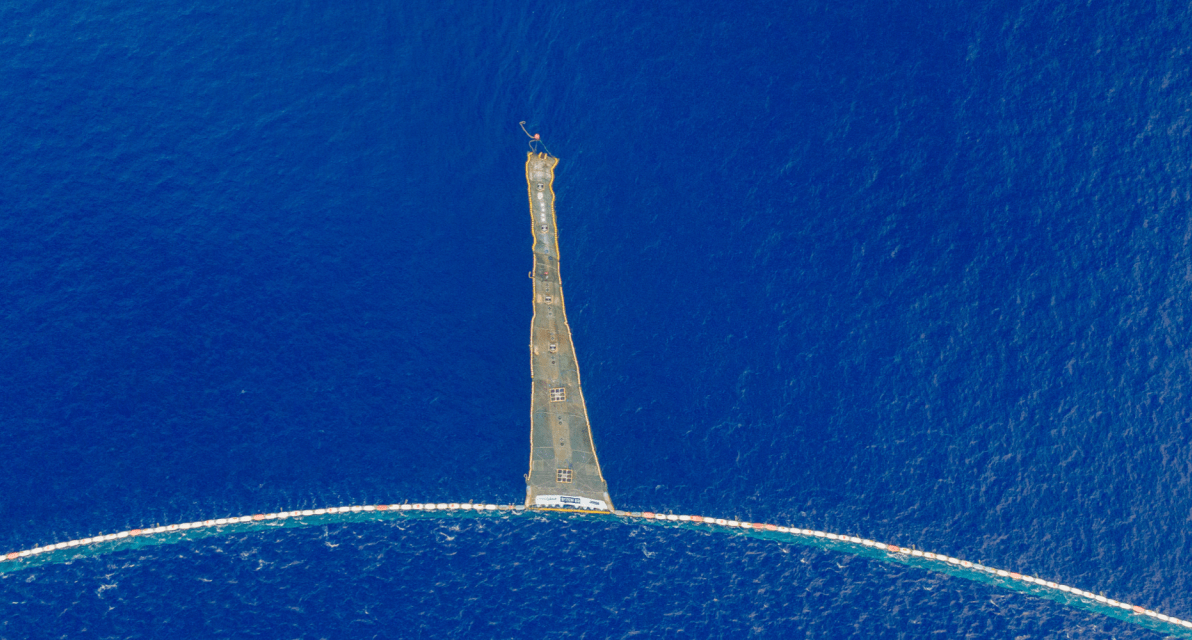A large, trash-collecting net floats at the service of the ocean. 