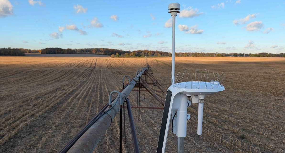 A close up view of equipment shown overlooking a crop field. 