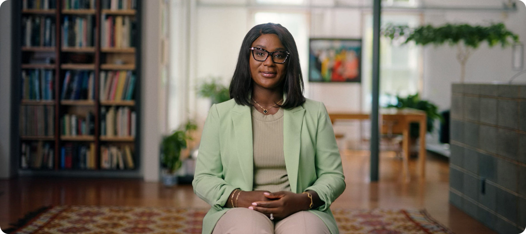 A person sitting in a room and smiling at the camera. 