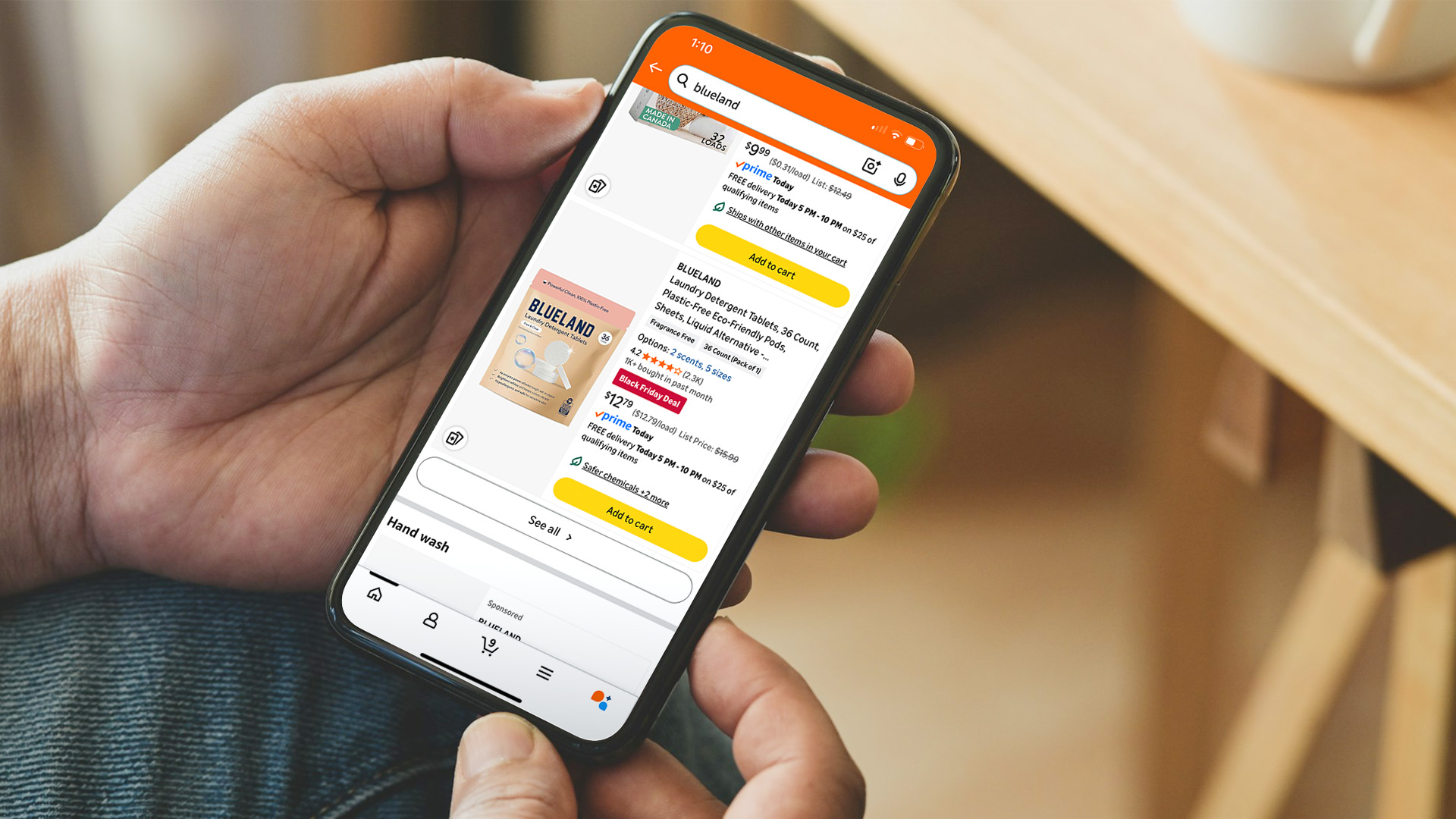 A person holds a phone while shopping online. 