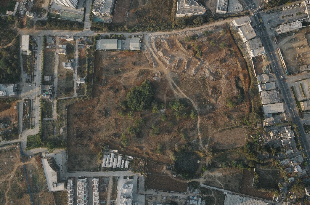 An overheard view of a construction site in a dry, urban setting. 
