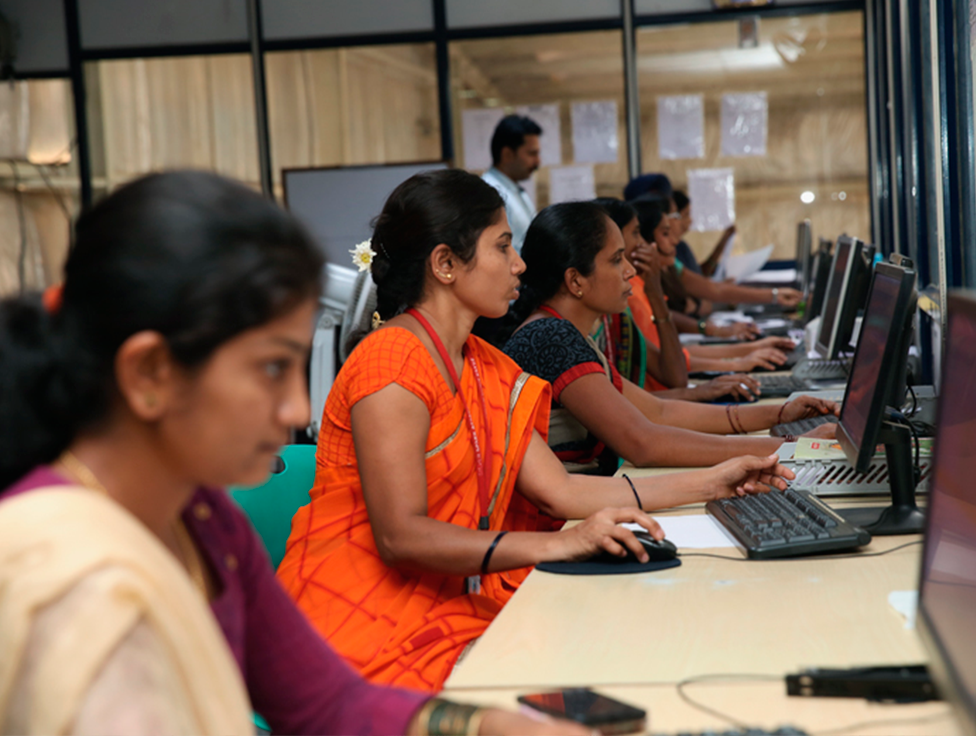 A group shot of people working on laptops. 